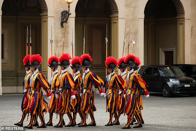 Swiss Guards march ahead of the King and Queen's arrival at San Damaso Courtyard today