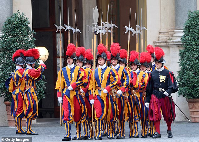Swiss Guards march ahead of the King and Queen's arrival at San Damaso Courtyard today
