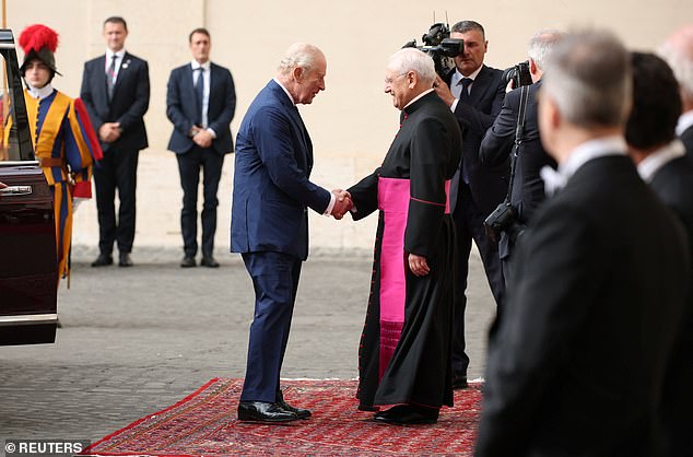 King Charles III and Queen Camilla are welcomed by officials at San Damaso Courtyard today