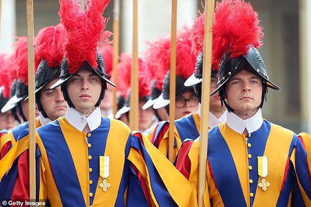 Swiss Guards march ahead of the King and Queen's arrival at San Damaso Courtyard today