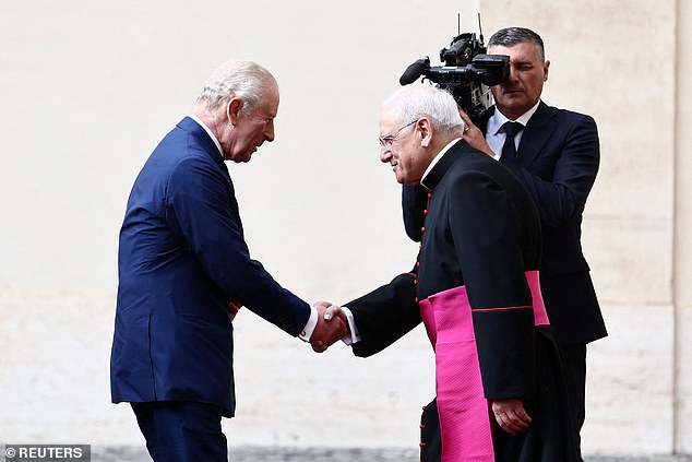 King Charles III is welcomed by officials at San Damaso Courtyard at Vatican City today