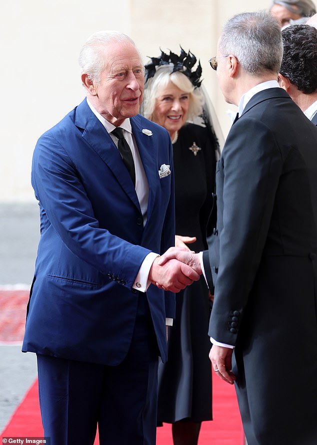King Charles III and Queen Camilla are welcomed by officials at San Damaso Courtyard today