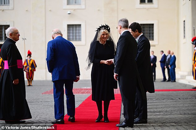 King Charles III and Queen Camilla are welcomed by officials at San Damaso Courtyard today