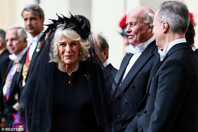 Queen Camilla is welcomed by officials at San Damaso Courtyard at Vatican City today