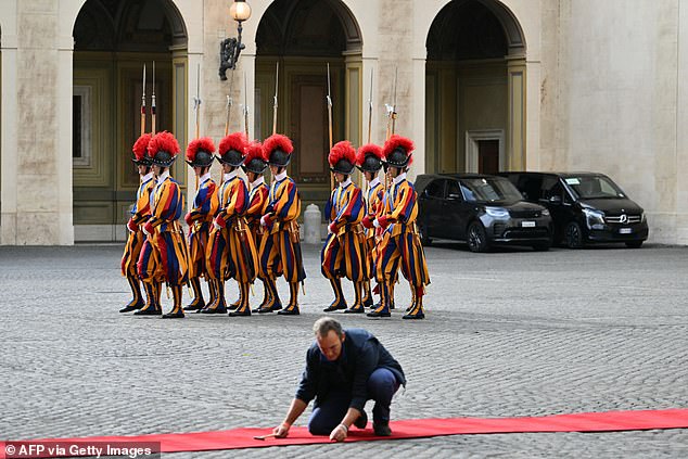 Swiss Guards march ahead of the King and Queen's arrival at San Damaso Courtyard today