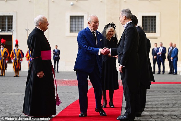 King Charles III and Queen Camilla are welcomed by officials at San Damaso Courtyard today