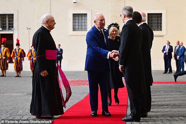 King Charles III and Queen Camilla are welcomed by officials at San Damaso Courtyard today