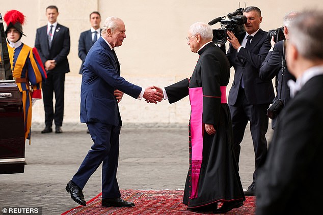 King Charles III and Queen Camilla are welcomed by officials at San Damaso Courtyard today