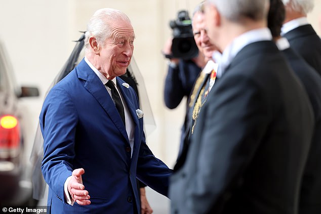 King Charles III and Queen Camilla are welcomed by officials at San Damaso Courtyard today
