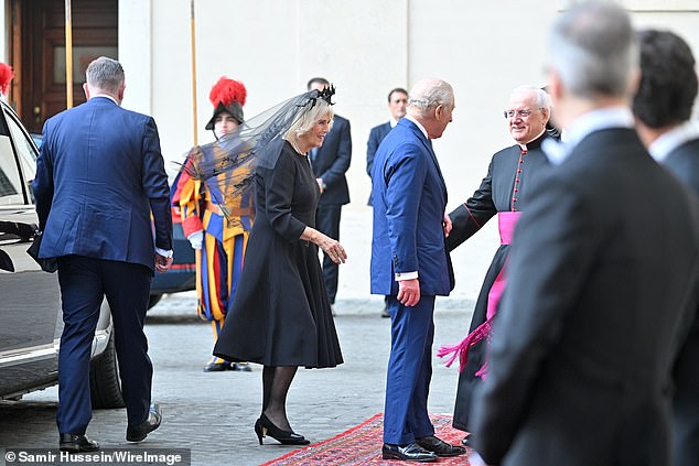 King Charles III and Queen Camilla are welcomed by officials at San Damaso Courtyard today