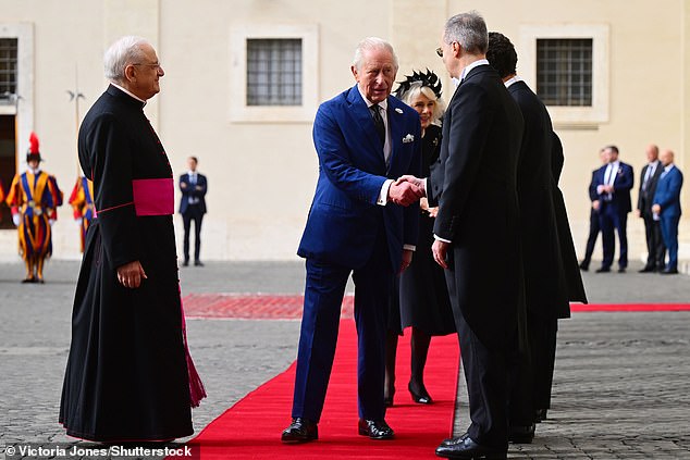 King Charles III and Queen Camilla are welcomed by officials at San Damaso Courtyard today