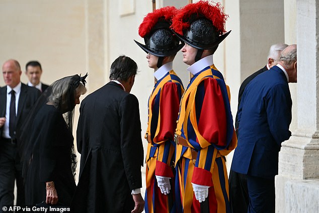 King Charles III and Queen Camilla are welcomed by officials at San Damaso Courtyard today