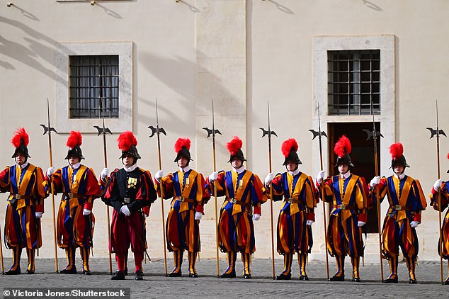 Swiss Guards stand ahead of the King and Queen's arrival at San Damaso Courtyard today