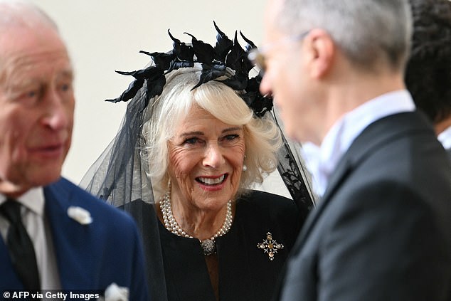 Queen Camilla is welcomed by officials at San Damaso Courtyard at Vatican City today