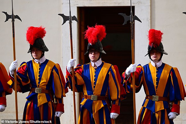 Swiss Guards stand ahead of the King and Queen's arrival at San Damaso Courtyard today