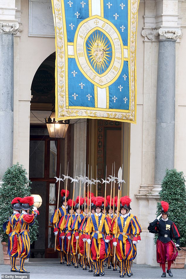 Swiss Guards march ahead of the King and Queen's arrival at San Damaso Courtyard today