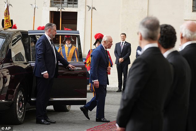 King Charles III and Queen Camilla are welcomed by officials at San Damaso Courtyard today