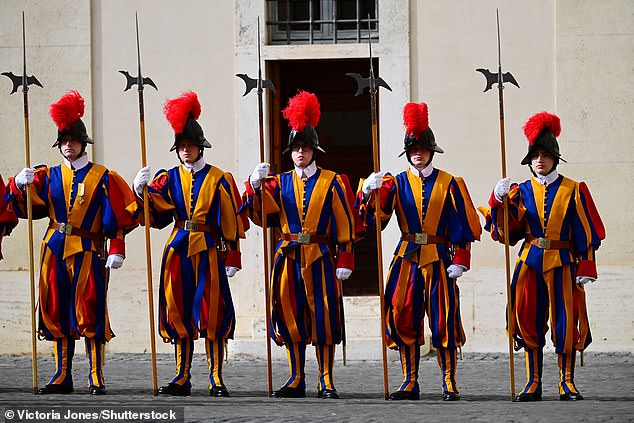 Swiss Guards stand ahead of the King and Queen's arrival at San Damaso Courtyard today