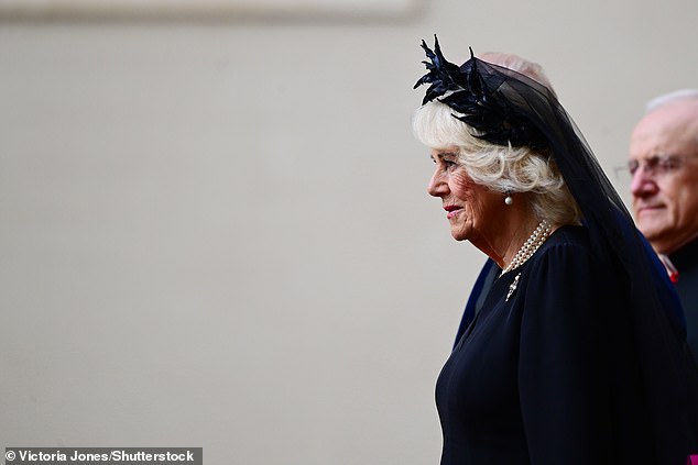 Queen Camilla is welcomed by officials at San Damaso Courtyard at Vatican City today