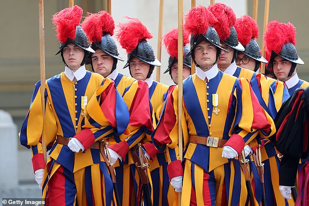 Swiss Guards march ahead of the King and Queen's arrival at San Damaso Courtyard today