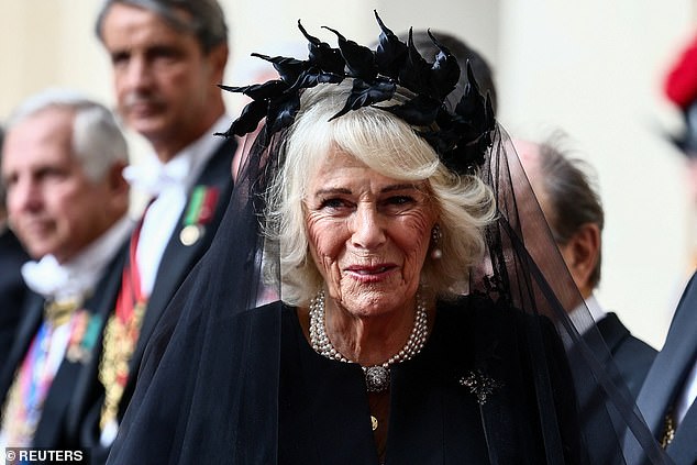 Queen Camilla is welcomed by officials at San Damaso Courtyard at Vatican City today