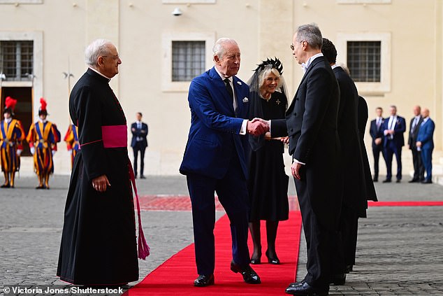 King Charles III and Queen Camilla are welcomed by officials at San Damaso Courtyard today