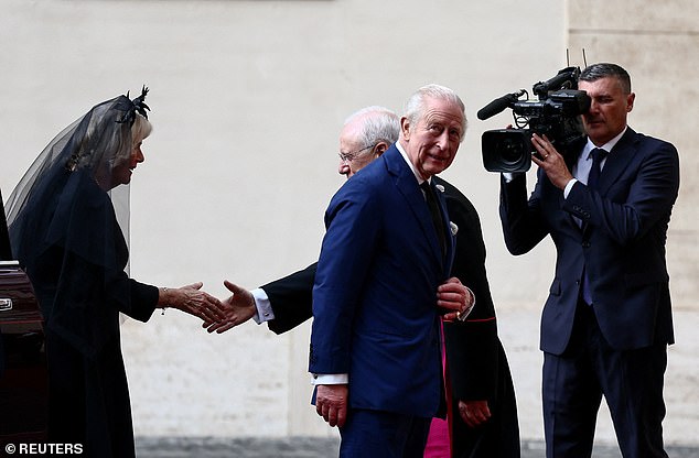 King Charles III and Queen Camilla are welcomed by officials at San Damaso Courtyard today