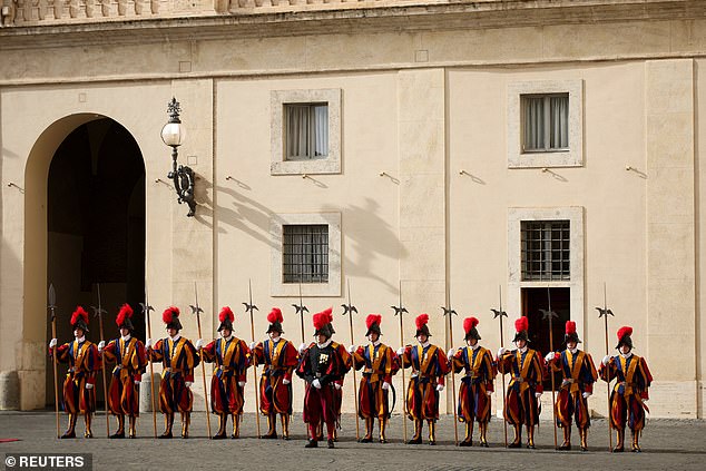 Swiss Guards stand ahead of the King and Queen's arrival at San Damaso Courtyard today