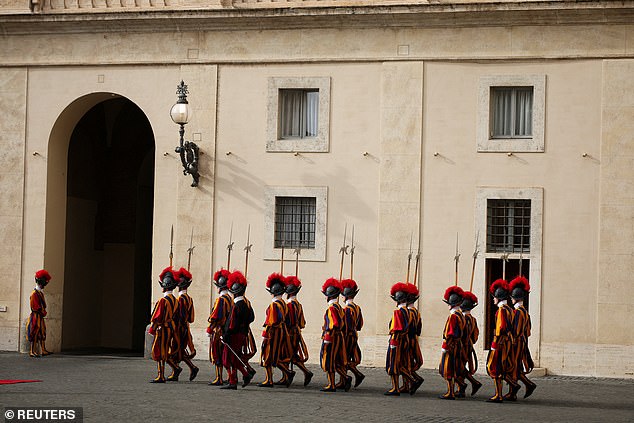 Swiss Guards march ahead of the King and Queen's arrival at San Damaso Courtyard today