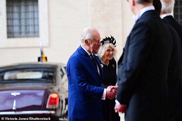 King Charles III and Queen Camilla are welcomed by officials at San Damaso Courtyard today