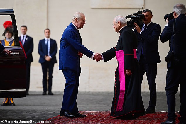 King Charles III is welcomed by officials at San Damaso Courtyard at Vatican City today