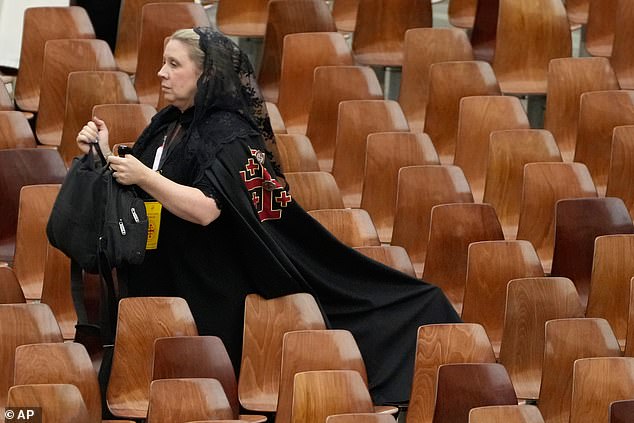 A member of the Equestrian Order of the Holy Sepulchre of Jerusalem waits to meet Pope Leo