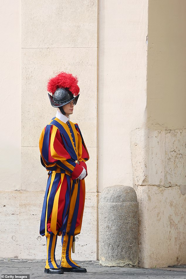 Swiss Guards stand ahead of the King and Queen's arrival at San Damaso Courtyard today