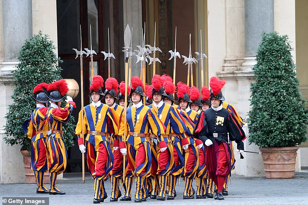 Swiss Guards march ahead of the King and Queen's arrival at San Damaso Courtyard today