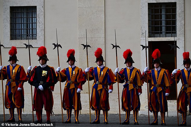 Swiss Guards stand ahead of the King and Queen's arrival at San Damaso Courtyard today