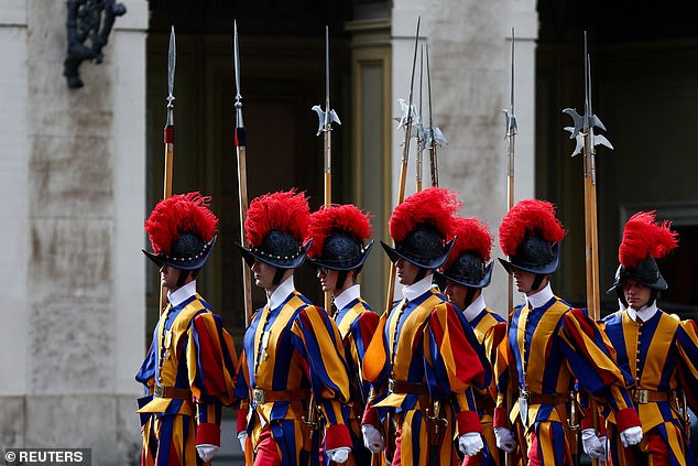 Swiss Guards march ahead of the King and Queen's arrival at San Damaso Courtyard today