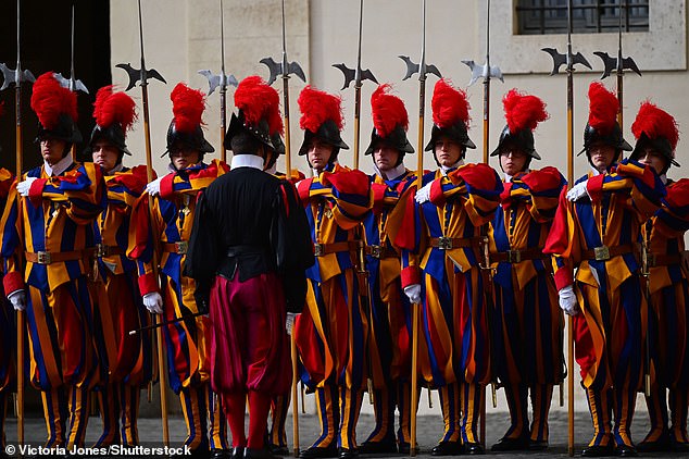 Swiss Guards stand ahead of the King and Queen's arrival at San Damaso Courtyard today