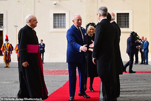 King Charles III and Queen Camilla are welcomed by officials at San Damaso Courtyard today