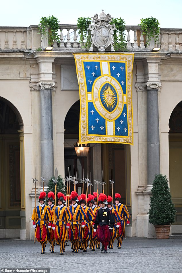Swiss Guards march ahead of the King and Queen's arrival at San Damaso Courtyard today