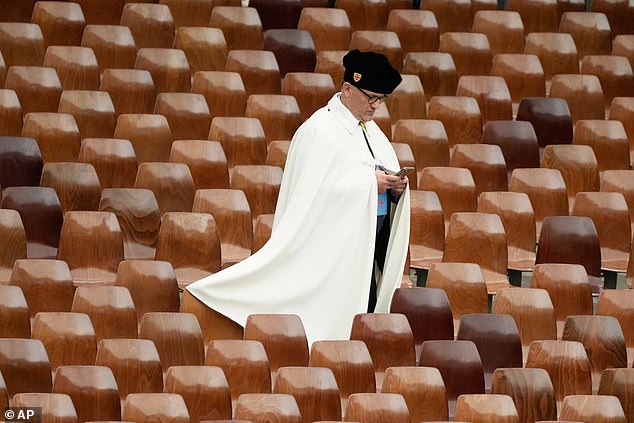 A member of the Equestrian Order of the Holy Sepulchre of Jerusalem waits to meet Pope Leo