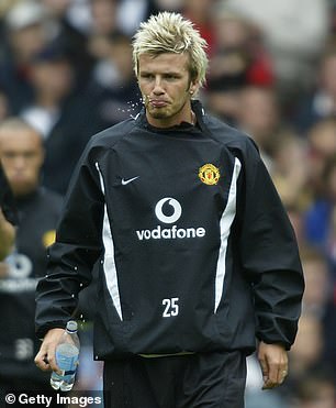 Former Manchester United ace David is pictured wearing one of the training tops during an open training day at Old Trafford in 2002