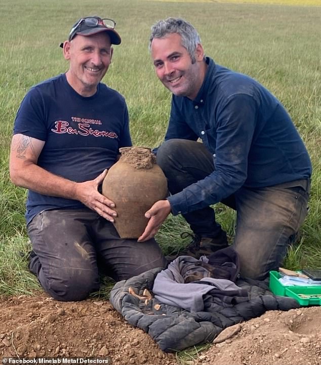 Mr Moss (right) with his friend Ian holding one of the clay pots