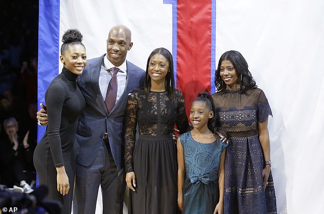 Chauncey Billups stands with his daughters Ciara, left, Cydney and Cenaiya and his wife, Piper, right, during a halftime ceremony during an NBA basketball game where his jersey was retired, Wednesday, Feb. 10, 2016 in Auburn Hills, Mich. (AP Photo/Carlos Osorio)
