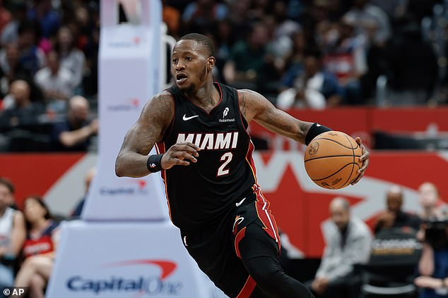 FILE - Miami Heat guard Terry Rozier (2) brings the ball up court during the second half of an NBA basketball game against the Washington Wizards in Washington, Monday, March 31, 2025. (AP Photo/Terrance Williams, File)