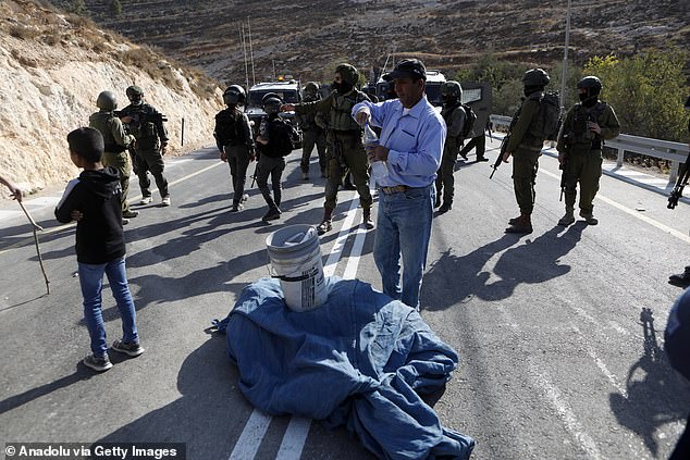 Trump said he gave his word to Arab countries he would not support Israel annexing the West Bank. Pictured: Israeli forces confront Palestinians in Hebron, West Bank, today