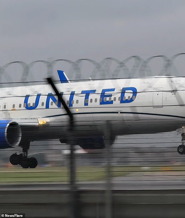 The United Airlines Boeing aircraft attempts to touch down, but despite being only metres away from the asphalt, strong winds make the manoeuvre impossible