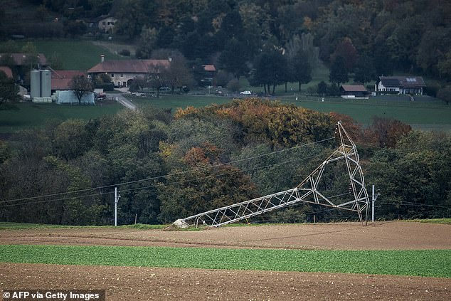 An electricity pylon is seen on the ground after being knocked down by strong winds during the autumn storm, Benjamin, which swept through Switzerland, near Biere on October 23, 2025