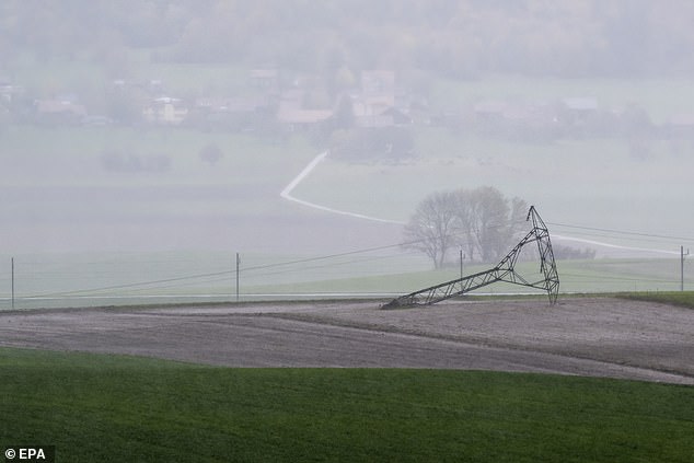 An electricity pylon is seen on the ground after being knocked down by strong winds during the autumn storm, Benjamin, in Biere, Switzerland, 23 October 2025
