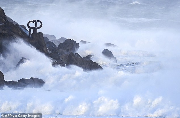Waves crash against the "Peine del Viento" (Wind Comb) sculptures by Spanish artist Eduardo Chillida during a weather alert for rough seas in the northern Spanish Basque city of San Sebastian on October 23, 2025