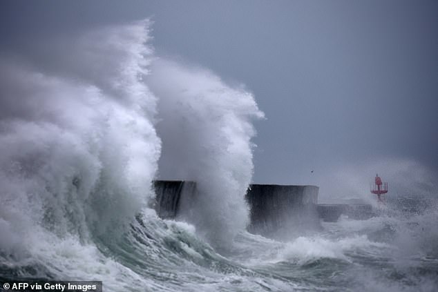 Waves hit the port of Plobannalec-Lesconil, western France October 22, 2024 as strong winds hit the coast at the passage of the storm Benjamin